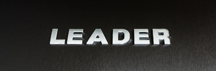 Word leader spelled with chrome letters on black background in a conceptual image of leadership