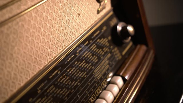 Close-up revealing shot of brown old vintage radio with dials