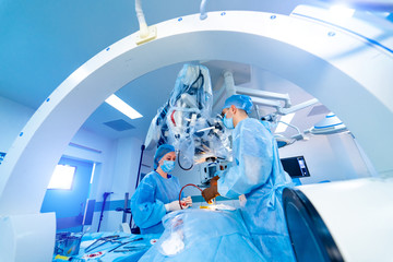 Process of trauma surgery operation. Group of surgeons in operating room with surgery x-ray...