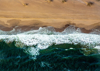 Naklejka na ściany i meble Aerial picture of the landscape of the Namib Desert and the Atlantic Ocean on the Skeleton Coast in western Namibia