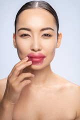 Smiling woman is keeping patches on lips