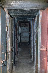 Fototapeta na wymiar Basement long corridor with old rusty metal doors