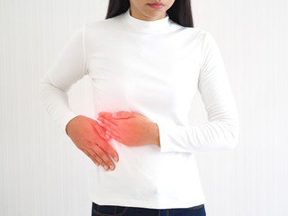 hepatitis and cirrhosis, including bile duct cancer in woman and she touching in the upper right portion of abdomen and above stomach symptoms of pain and suffering use for health care concept.