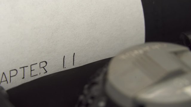 Typing CHAPTER 2 in black ink on an old mechanical typewriter.