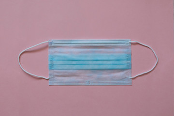 Doctor medical mask and coronavirus protection isolated on a pink background.