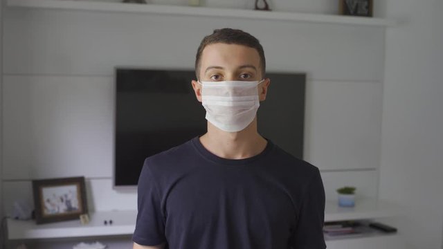 young man wearing white mask to prevent coronavirus