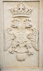 Fototapeta na wymiar Ceramic bas-relief of a double-headed eagle for decoration of buildings and interiors.