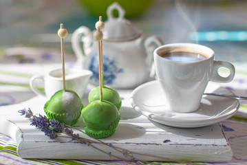 cake pop with morning coffee and cream on a napkin on a board with lavender in the style of provence