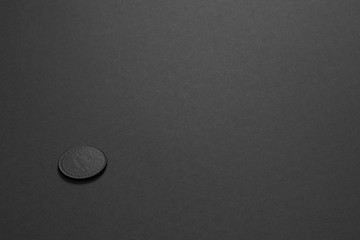 Black matte bitcoin on the black background. Minimal style. Minimal art. Matte surface. Isolated. One. Copy space