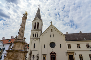 Fototapeta premium Views of the city of Veszprem with king Saint Stephen / Szent Istvan cathedral and trinity statue on the trinity square