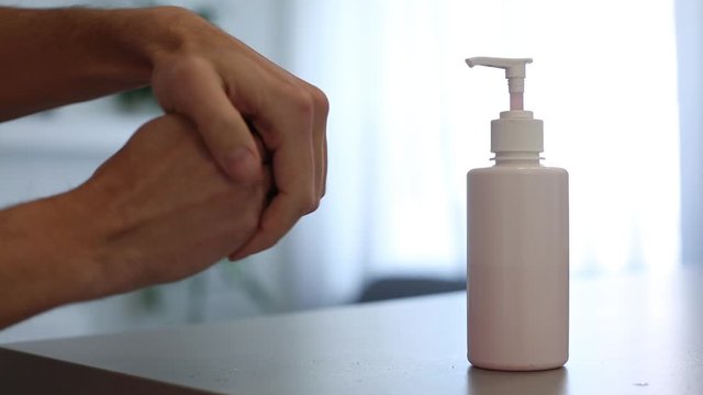 Coronavirus hand sanitizer sanitiser gel for clean hands hygiene corona virus spread prevention. Woman using alcohol rub alternative to washing hands. REAL TIME video.