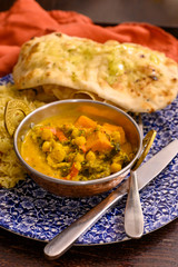 Mangalorean style roasted cauliflower and spinach curry with basmati rice and garlic naan bread, tasty vegetarian food