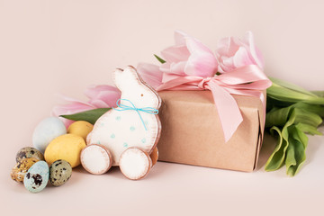 Beautiful Easter composition of eggs with natural colors, gingerbread, flowers, feathers.