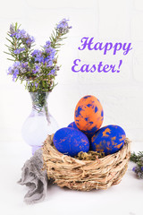 Easter card. A nest with easter eggs and rosemary close up on a white background