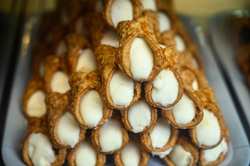 Sweet italian desssert, pile of cannoli pastry filled with ricotta cream cheese