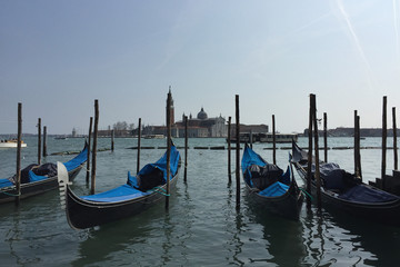 Obraz na płótnie Canvas Venetian boats gondolas in harbor in Venice, Italy.