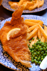 Traditional British food fish and chips served with green peas