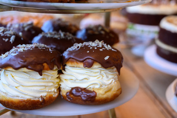 Scottish cream choux buns with chocolate close up