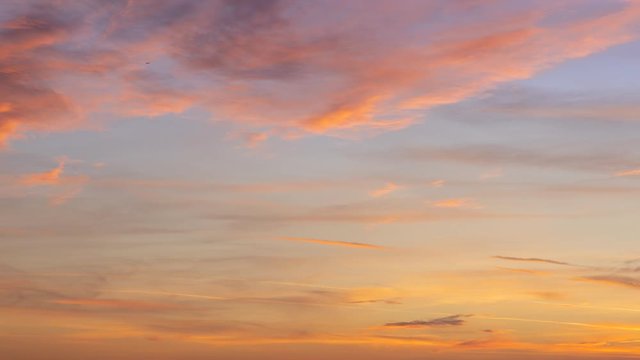 Time lapse. Sunset sky with soft and blur pink and orange pastel colored clouds. gradient heaven on the beach resort. nature. sunrise.  peaceful morning. Instagram toned style