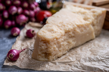 One piece of authentic Parmigiano-Reggiano or Parmesan Italian hard, granular cheese