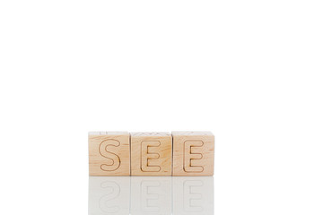 Wooden cubes with letters see on a white background