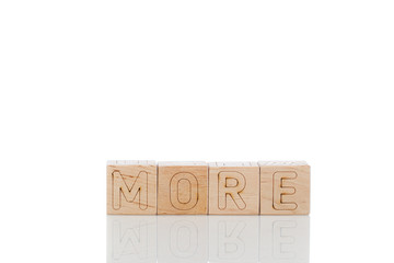 Wooden cubes with letters more on a white background