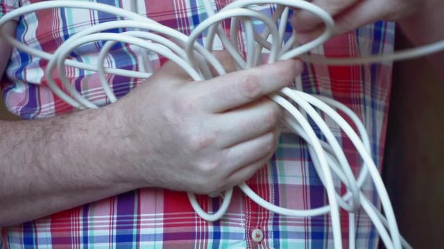 electrician at work.men's hands unravel electrical wires