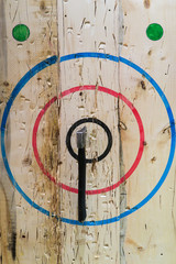 An axe stuck in the middle of the bullseye during an axe-throwing competition