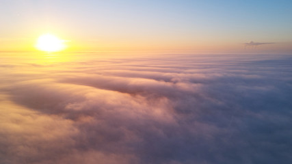 Fototapeta na wymiar Sunrise above clouds