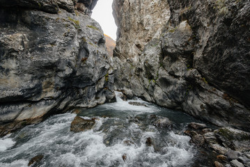A stormy mountain river flows through a gorge of mountains. Nature.