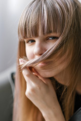 Naklejka premium Close-up portrait of a beautiful teenage girl of the European race. Studio photo shoot. Photo with blurred background.