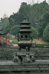 Fototapeta na wymiar Traditional bronze censer burner on stone turtle statue in Huayan Temple