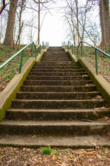Looking Up a Concrete Stairwell in a Park With Green Railings on Each Side