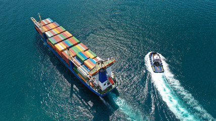 Aerial drone top down photo of fully loaded large truck size container tanker ship cruising the...