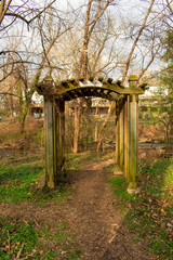 A Small Wooden Gazebo With a Path Running Through It