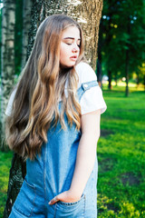 Fototapeta premium young pretty sensual girl with fashion makeup posing in birch tree forest, lifestyle people concept