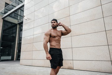 Sexy man posing topless in the hot sun. Fitness. Lifestyle