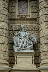 Fototapeta na wymiar Decorative marble sculptures and columns on the facade of the building of the National Museum of Natural History in the building of the Hofburg Palace in Vienna, Austria