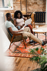 Obraz premium Beautiful Afro American couple spending time at home