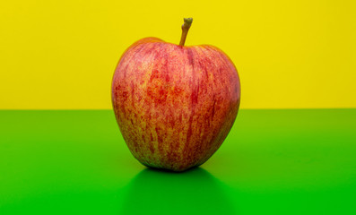 red apples on green and yellow background