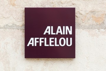 Villefranche, France - September 22, 2019: Alain Afflelou logo on a wall. Alain Afflelou is a French company, chain of opticians specialized in the distribution of frames and optical glasses
