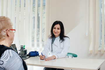 A couple of elderly people at a personal doctor's appointment at a medical center. Medicine and healthcare