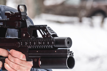 The hired soldier aims from a modern rifle with an under-barrel grenade launcher.