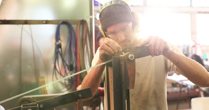 Bladesmith sharpening a blade on belt grinder