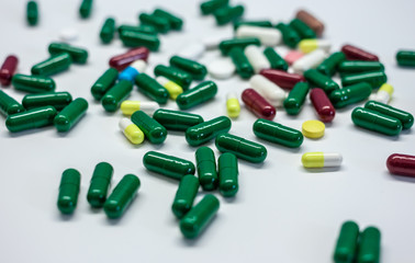 pills and capsules on white table surface