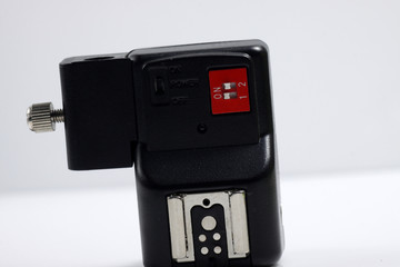 Close up shot of black camera flash trigger isolated on white background