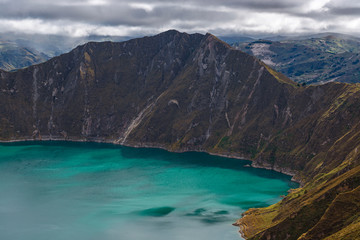 The highest peak of the Quilotoa Loop at 3914 meters high with the turquoise colors of the crater lagoon in the Andes mountain range, south of Quito, Ecuador. 