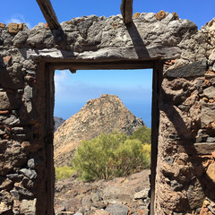 Volcanic mountain seen throught the frame of an old house