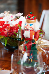 Holiday Decoration, Nutcracker with tropical red and white flowers on background