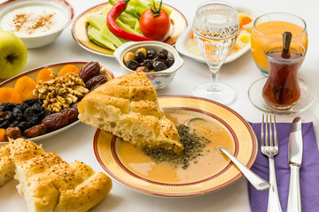 Traditional Turkish Ramadan Iftar,Dinner Table With Soup and sliced Ramadan Bread in soup.
